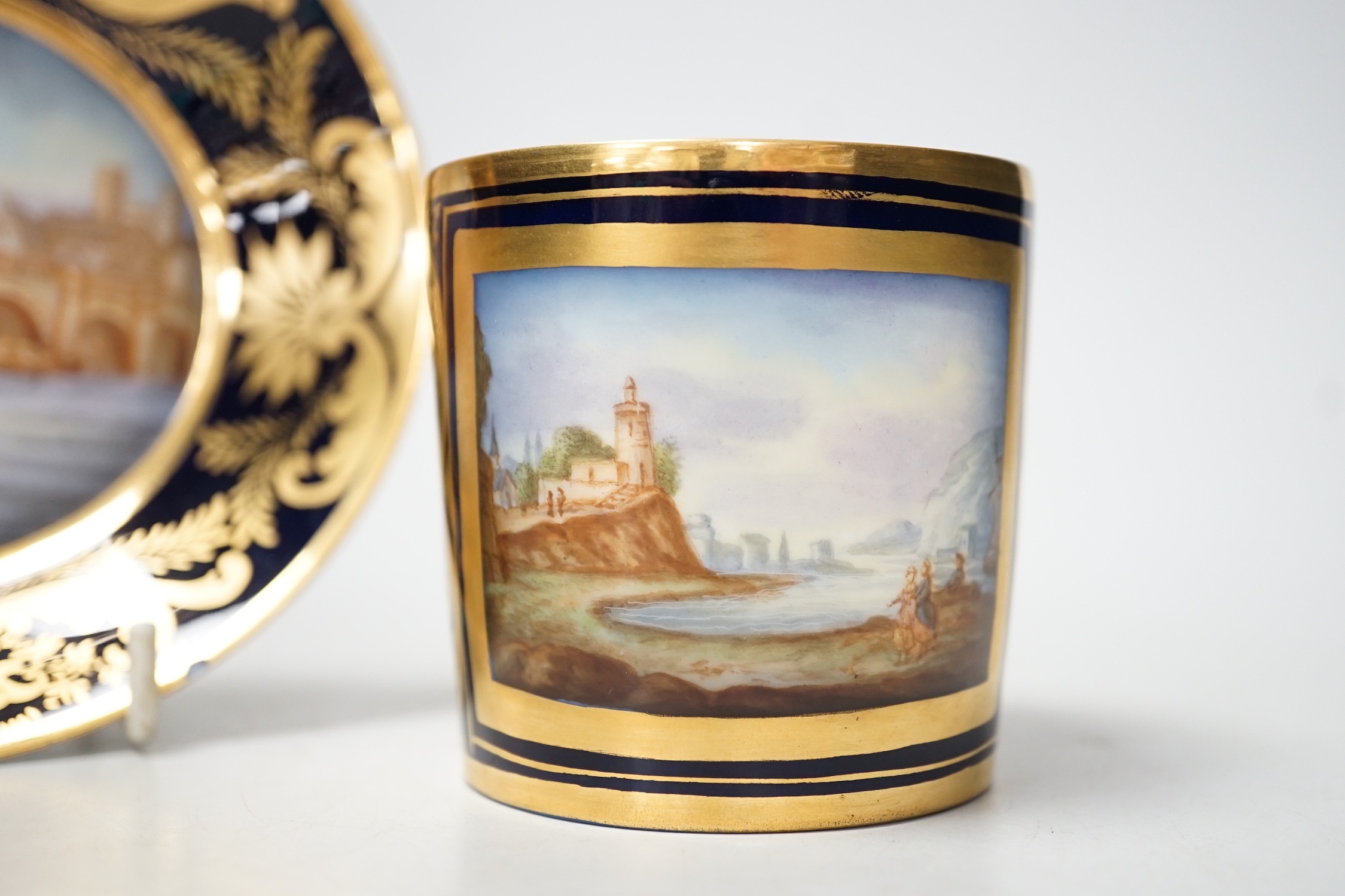 A Continental Derby style cup and saucer, 8cm tall overall